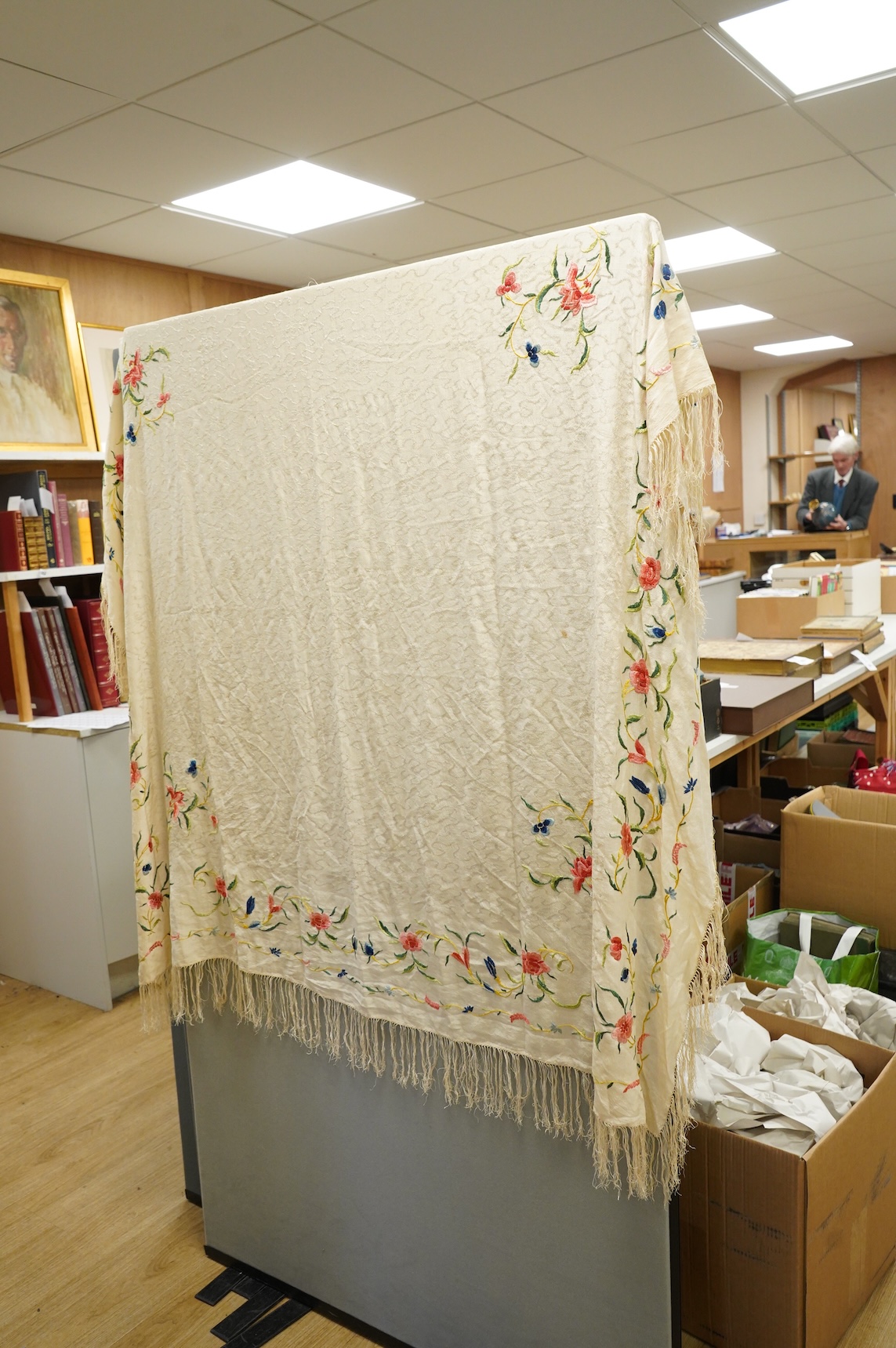 An early Chinese 20th century cream silk damask shawl with a polychrome floral silk embroidered border and a silk fringe, 150cm x 150cm, together with a smaller shawl/scarf, the corner cream on cream embroidered and edgi